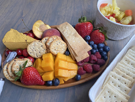 COOL ANDTASTY An assortment of fruits, crackers, and cheeses, artistically arranged. makes for a great“cold plate”on summer days. | ANGELINA LaRUE PHOTO