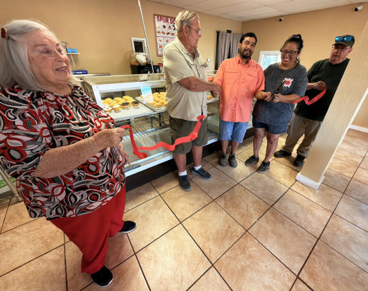 DONUTS TO DOLLARS is what Elida and Raymond Rodriguez of Crosby County will seek to achieve as the new proprietors of Spur’s donut-and-lunch spot at 410W. Hill Street.Their newly named R2 Donuts was welcomed with a ribbon cutting Aug. 22 by the Spur Area Chamber of Commerce. Mayor John Schmidt did the honors, assisted by members Martha Pickens (far left) and Steve Bridges (far right). | TEXAS SPUR