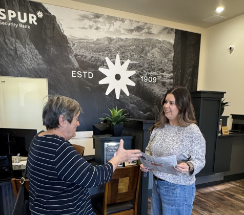 BRANCHING OUT Last Friday Texas Spur publisher Kay Ellington paid a visit to the new Lubbock branch of Spur Security Branch and presented copies of the newspaper carrying the story of the bank’s first branch outside its home county. | COURTESY PHOTO