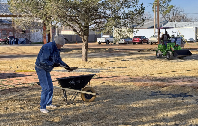 Last week, before frigid temperatures set in, volunteers turned out to help John Eric Swenson and his crew spread crushed rock to create a xeriscape around the brick walkways in Rickels Park at Third Street and Burlington Avenue. | THE TEXAS SPUR