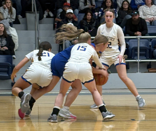 The Spurette defense swarms a Lady Patriot. Kimberlee Segura (21), Erin McGalliard (15), and KayganWalker (22) apply pressure.