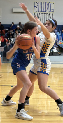 Addison Fulmer (right) traps a Lady Patriot.