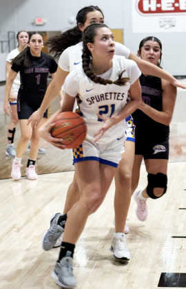 DRIVES INSIDE Senior Kimberlee Segura drives inside for a score against Meadow Feb. 20.