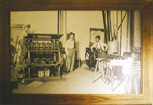 JOB CASES OF METAL TYPE were used in setting display and body copy of the frontier newspaper to begin with. In the 1920s, The Texas Spur acquired a Linotype machine and a larger printing press. The man in the hat at center of the bottom photo is founding publisher Oran R. McClure. | SPUR DICKENS COUNTY MUSEUM