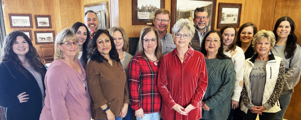 SPUR BANK FAMILY on the occasion of Elaine Key’s retirement as president in December 2023 includes Melanie McCormick (in red plaid, to Key’s right), now marking 35 years with the organization. | TEXAS SPUR