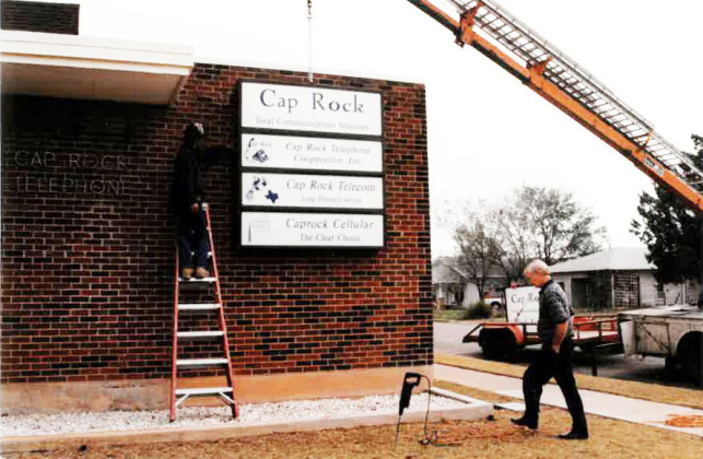 EXPANDINGENTERPRISE Whitefieldoversawconstructionofexpandedfacilities for the coop over the years, including new signage added to the Third Street headquarters in 1997 and addition of a warehouse across the street in 2001. | CAP ROCK TELEPHONE