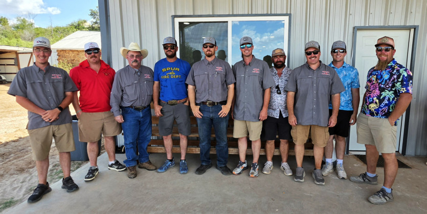 COOL FIREFIGHTERS turned out for a hot day on the Spur links in more colorful duds than when they’re on fire duty.