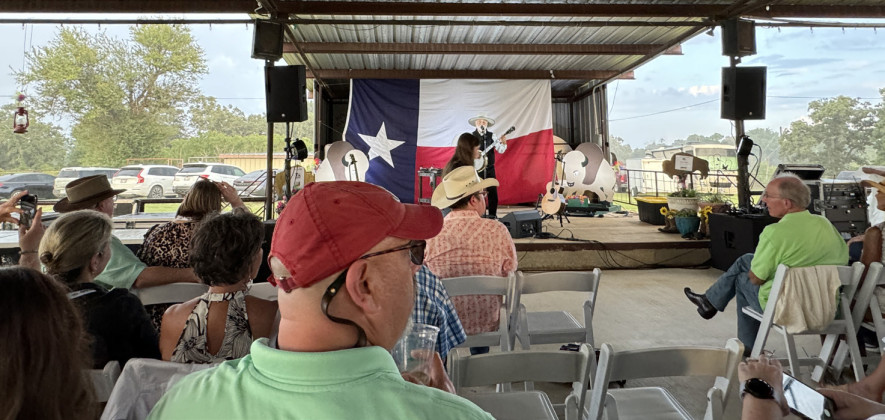 RAINBOW ON THE RANCH Michael Muartin Murphey, featured entertainer at the Texas Press Association dinner June 21, didn’t miss a beat when a rainstorm blew in behind the outdoor stage June 21. | THE TEXAS SPUR