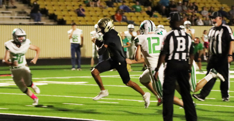 JAYTONWINS #13 Quarterback Sean Stanaland breaks free and finds an opening to score in the end zone, and #23 Cutter Lee ensures that Newcastle is stopped. The #1 in the state Jaybirds defeated the Newcastle Bobcats 72-22 just after the half. | JGISD YEARBOOK PHOTOS
