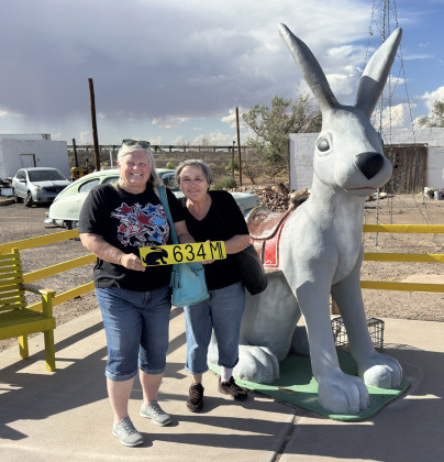 HERE WE ARE Kay and Barbara with our own sign to remind us the distance from back home to the Jack Rabbit. | COURTESY PHOTO