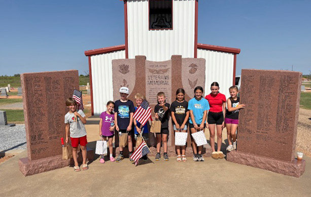 MEMORIALFLAGS Youngsters from Kent County assisted last week in placing U.S. flags at the Girard Cemetery to honor military veterans buried there. From left, participants were Noah Bryant, Kate Appleby, Micah Appleby, Wade Appleby, Quincy Hall, Violet Vargas, Marley Nall, Paisley Bryant and McKye Hall; Sidney Hall was not pictured. | COURTESY PHOTO
