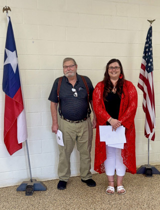 NEW SPUR MAYOR John Schmidt, elected May 3 over opponent Billy R. Spears, was inducted into office May 20 to succeed Louise Jones, who is retiring after two years on city council and eight years as mayor. All oaths were administered by City Secretary Ashley Carothers (right). | THE TEXAS SPUR