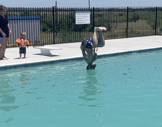 HISTORIC BATHHOUSE at Swenson Park is the entry for patrons headed to swim in the newly reopened pool. Committee members spent several days before the Memorial Day grand opening, sweeping out blown-in red dirt, mopping floors, stocking refrigerators, and installing signage, while city tech crews mowed, delivered refrigerators, and cleaned up debris and trash.“The Spur pool truly embodies the spirit of our community,”said Spur Mayor Louise Jones at Monday’s event. | THE TEXAS SPUR