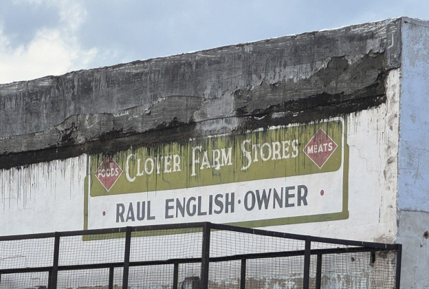 PASTYIELDSTO FUTURE The Clover Farms business sign painted on the unsalvageable stuccoed side of the hundred-year-old structure at 507 Burlington Avenue became a part of Spur’s memory when the building that later housed Wyatt’s Tractor Service was taken down Monday. The building is the second to be razed to make way for new Spur Volunteer Fire Department facilities. | THE TEXAS SPUR