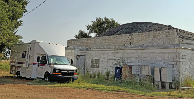 (top) is among other structures repaired or replaced after the 2023 storm, but it's pening an inspection correction. McAdoo addresses continue to get their delivery at temporary boxes (below).