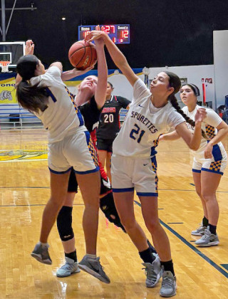 QUEEN AND COURT The Spurettes' Keylee Molina (left) and Kimberlee Segura (21) deny a LadyTiger the shot under the basket. MORE PHOTOS, PAGE 8 | SUE JANE SULLIVAN PHOTOS