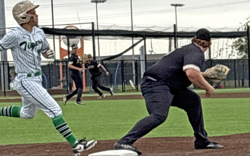 FIRST BASEMAN GARRISON ALLEN takes the throw from third baseman Cody Nail to get the out ahead of a May runner.