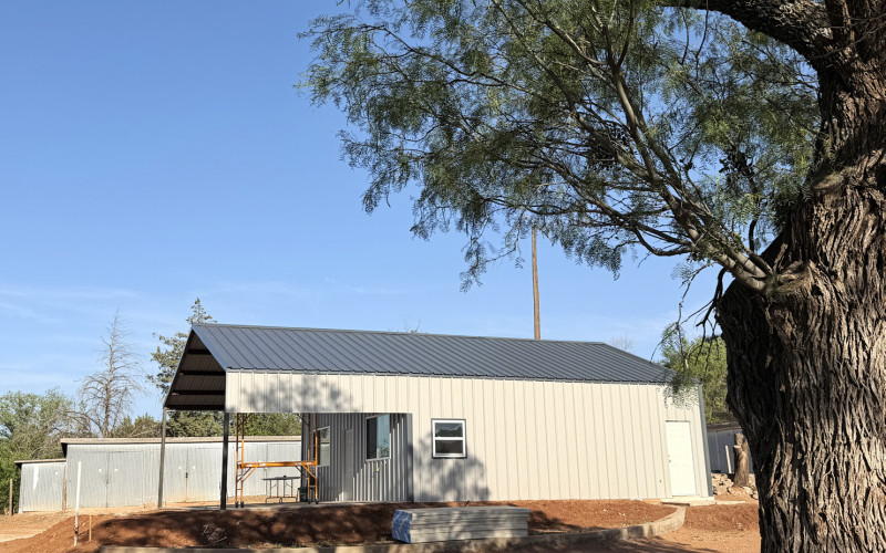 UNDER SHADY MESQUITES a new clubhouse has been taking shape for the Spur Golf Association. The new metal building replaces an old wood-frame structure. The SGA obtained a forgivable loan of $25,000 from the Spur Economic Development Corporation to help defray construction expenses. | TEXAS SPUR
