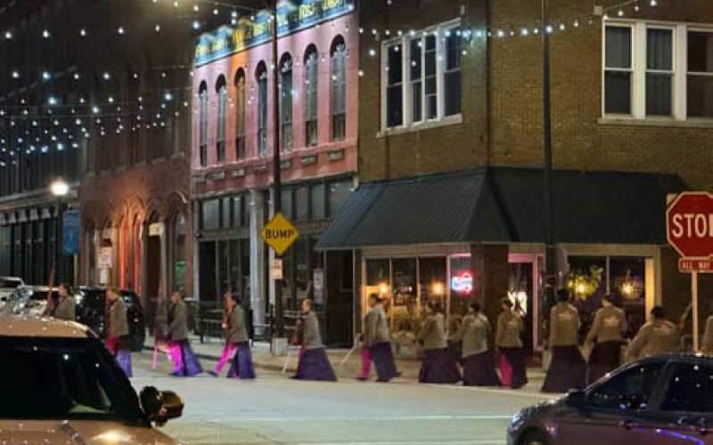 SURREAL SCENE in predawn downtown Springfield, Missouri, April 30 is really nothing more than the Southwest Missouri State flag corps proceeding to their lineup point for the filming of an NBC-TV“Today Show Third Hour Live”segment on the birthplace of Route 66.
