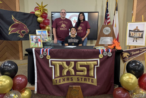 SIGNING DAY Jayton senior Sean Stanaland (center, with parents) who has earned statewide honors in track, football and basketball signed a letter of intent in track last week with Texas State University in San Marcos. The Bobcats currently compete in the NCAA Division I (FBS) as a member of the Sun Belt Conference. The university has announced it will officially join the Pac-12 Conference starting in the 2026-27 athletic season. Stanaland’s signing was celebrated by family and classmates. | COURTESY PHOTO