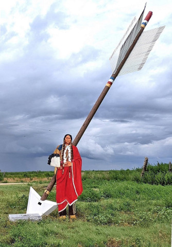 A QUANAH CUTOUT stands next to a Quanah Parker Trail arrow at Wayside, Texas, near to the trailwhere150yearsago,onSeptember28,1874, in the Battle of Palo Duro Canyon, Col. Ranald S. Mackenzie and the 4th Cavalry descended to the canyon floor and ambushed Comanche, Kiowa and Cheyenne bands seeking refuge there from the converging U.S. forces trying to force them onto reservations —but Quanah with his band of Kwahada were elsewhere. | TEXAS PLAINS TRAIL REGION