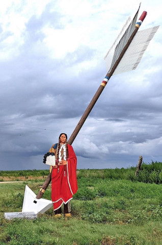 A QUANAH CUTOUT stands next to a Quanah Parker Trail arrow at Wayside, Texas, near to the trail where 150 years ago, on September 28, 1874, in the Battle of Palo Duro Canyon, Col. Ranald S. Mackenzie and the 4th Cavalry descended to the canyon floor and ambushed Comanche, Kiowa and Cheyenne bands seeking refuge there from the converging U.S. forces trying to force them onto reservations —but Quanah with his band of Kwahada were elsewhere. | TEXAS PLAINS TRAIL REGION