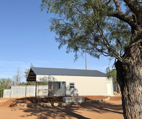 UNDER SHADY MESQUITES a new clubhouse has been taking shape for the Spur Golf Association. The new metal building replaces an old wood-frame structure. The SGA obtained a forgivable loan of $25,000 from the Spur Economic Development Corporation to help defray construction expenses. | TEXAS SPUR