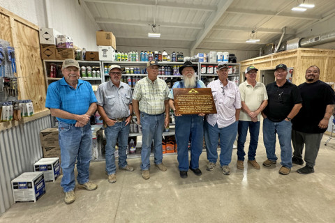 CROSBY COUNTY FUEL ASSOCIATION GRAND REOPENING PRIDE AND RESILIENCE are celebrated in the text of the large, custom-made wooden plaque presented to the Crosby County Fuel Association’s McAdoo location last Friday by general manager Steve Riley. From left, board members Bobby Binder, Dusty Cornelius, Joe Mark Cargile, Mack Gardner (with plaque), Mark Schoepf, Brad Aycock and Russ Edinburgh, and store manager Luis Guzman. | THE TEXAS SPUR