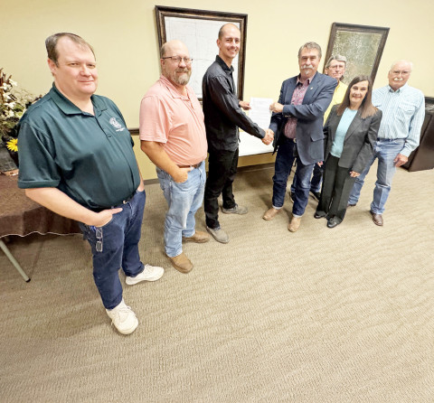 SEALING THE DEAL for a $20.5 million PILOT abatement agreement between Galaxy Digital and Dickens County July 28 are, from left, Dickens County Attorney Aaron Clements, County Commissioner Chris Horn, Galaxy Digital Vice President of Strategy Anthony Scheercousse, County Judge Kevin Brendle, County Commissioner Dennis Wyatt, Galaxy representative and Dickens County resident Barbara Bogart and County Commissioner Mike Smith. Commissioner Greg Arnold was absent. | THE TEXAS SPUR
