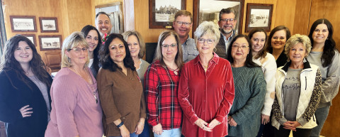 SPUR BANK FAMILY on the occasion of Elaine Key’s retirement as president in December 2023 includes Melanie McCormick (in red plaid, to Key’s right), now marking 35 years with the organization. | TEXAS SPUR