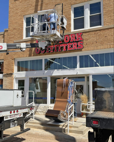 JUST FOR KICKS A custom-crafted giant neon boot was installed this summer at the Salt Fork Outfitters western-wear store and boot shop on Burlington Avenue. The former three-story office building, now adjoining Spur Hardware and under the same ownership, has been transformed into a shopping mecca for clothing, footwear, jewelry, and gifts--as well as the headquarters for a mobile showroom that can travel to rodeos and other events. | THE TEXAS SPUR