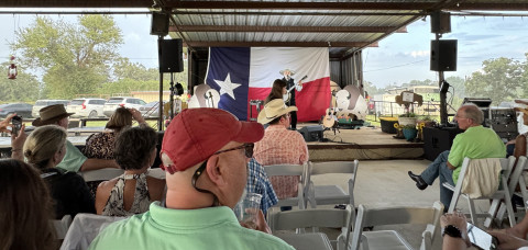 RAINBOW ON THE RANCH Michael Muartin Murphey, featured entertainer at the Texas Press Association dinner June 21, didn’t miss a beat when a rainstorm blew in behind the outdoor stage June 21. | THE TEXAS SPUR