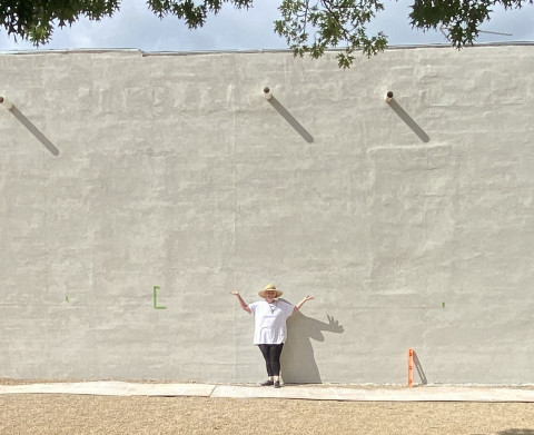 The masonry repair and undercoat on the north wall of the Spur Exes building (facing Rickels Park) has been completed—and the surface awaits a new mural by Spur artist Vicki Glass Diggs (center) Any guesses what it might be? | COURTESY PHOTO
