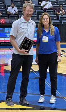 COACH OF THE YEAR Jayton Basketball Coach Ryan Bleiker was recognized as the 1A Basketball Coach of the Year by Vickie Benson (right), vice-president of the Texas Association of Basketball Coaches, at the organization’s meeting this weekend in San Antonio. Bleiker led the Jayton varsity boys’ basketball team to the school’s first-ever State championship in March. | COURTESY PHOTO