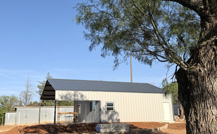 UNDER SHADY MESQUITES a new clubhouse has been taking shape for the Spur Golf Association. The new metal building replaces an old wood-frame structure. The SGA obtained a forgivable loan of $25,000 from the Spur Economic Development Corporation to help defray construction expenses. | TEXAS SPUR