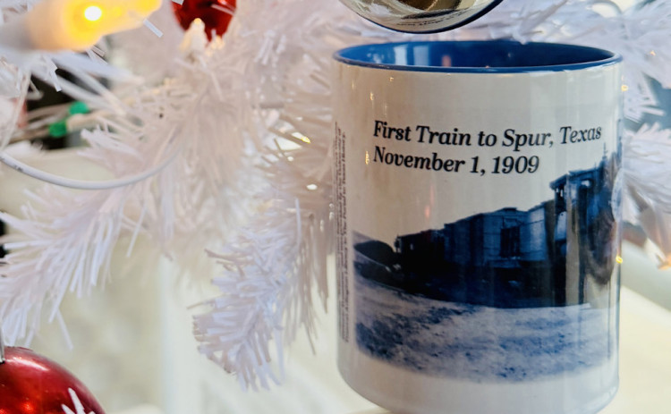 SPURCOMMEMORATIVECOFFEEMUG TheTexasSpurnewspaper has revealed the design of its 2025 holiday commemorative mug: “The First Train to Spur, Nov. 1, 1909.” The limited-edition mug is on sale now at the newspaper office or via mail-order, for $15 (sales tax included; shipping additional). | TEXAS SPUR PHOTO