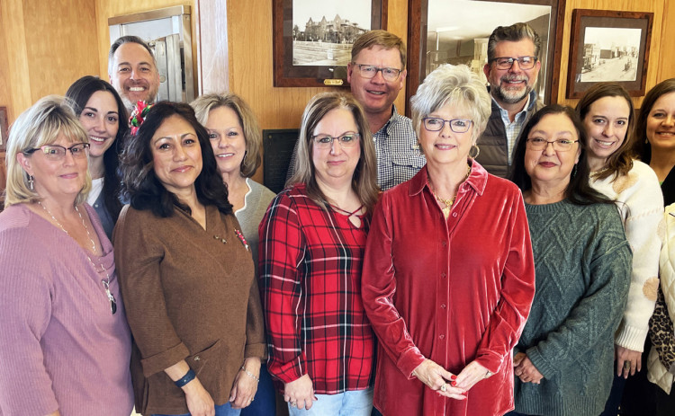 SPUR BANK FAMILY on the occasion of Elaine Key’s retirement as president in December 2023 includes Melanie McCormick (in red plaid, to Key’s right), now marking 35 years with the organization. | TEXAS SPUR