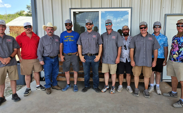 COOL FIREFIGHTERS turned out for a hot day on the Spur links in more colorful duds than when they’re on fire duty.