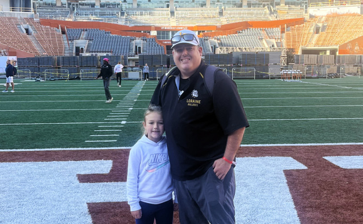 NEW SPUR COACH, ATHLETIC DIRECTOR Mark Weaver, pictured with daughter McKye at DKR Texas Memorial Stadium. | COURTESY PHOTO