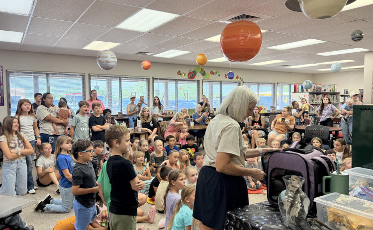 WHAT ON EARTH is about to come out of that carrier? A capacity crowd of youngsters and parents waited to find out, as South Plains Wildlife Rehabilitation staffers prepared to talk about how to “Unearth a Story” in this year’s summer reading theme with numerous rescued reptiles, mammals and birds. Programs continue at the Dickens County Spur Public Library Tuesday mornings at 10, for the next three weeks. | TEXAS SPUR